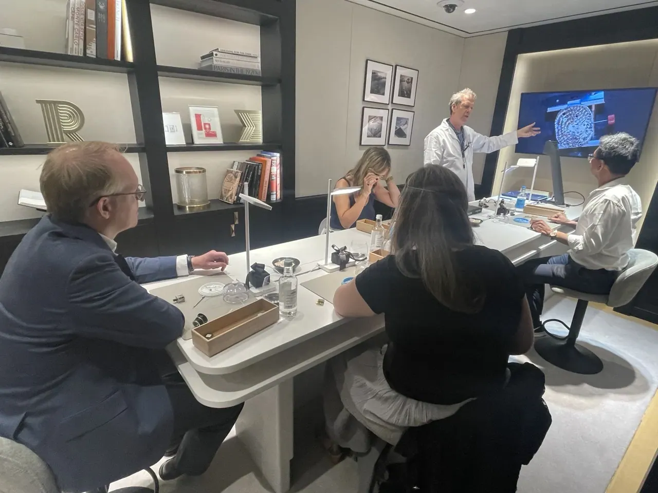Members seated around a watchmaker’s worktable during a private masterclass